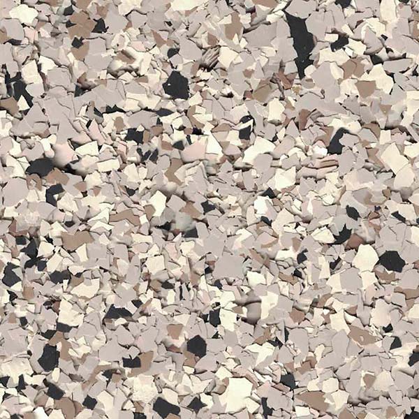 A textured surface with a mix of beige, brown, and black flakes, resembling a speckled pattern often used in flooring or countertops.
