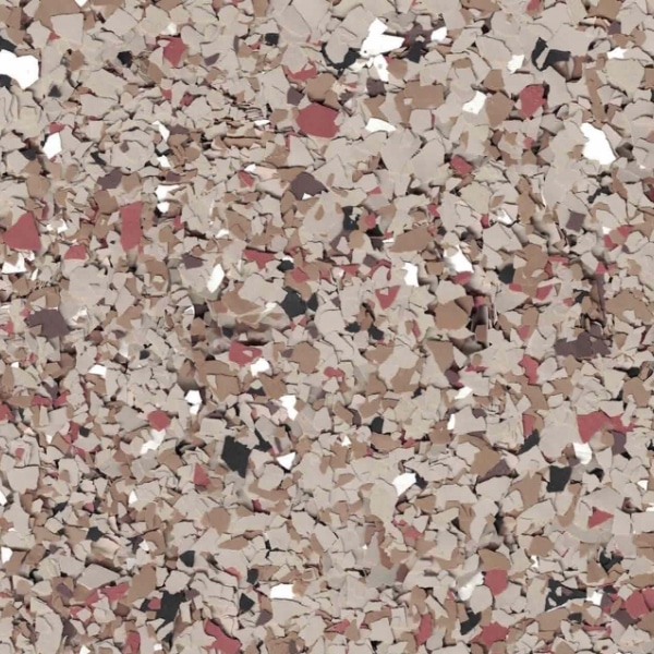 A close-up image of multicolored, irregularly-shaped pieces resembling chipped paint or confetti, in shades of beige, brown, red, and black.