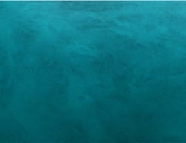 The image shows a textured, teal surface. There are no people, landmarks, or historical buildings present.