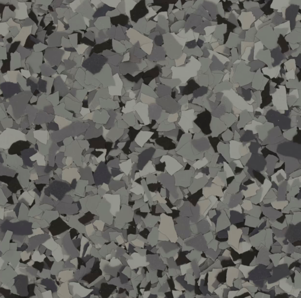 The image shows a close-up of a terrazzo floor pattern, featuring irregularly shaped gray, black, and white chips in a cement matrix.