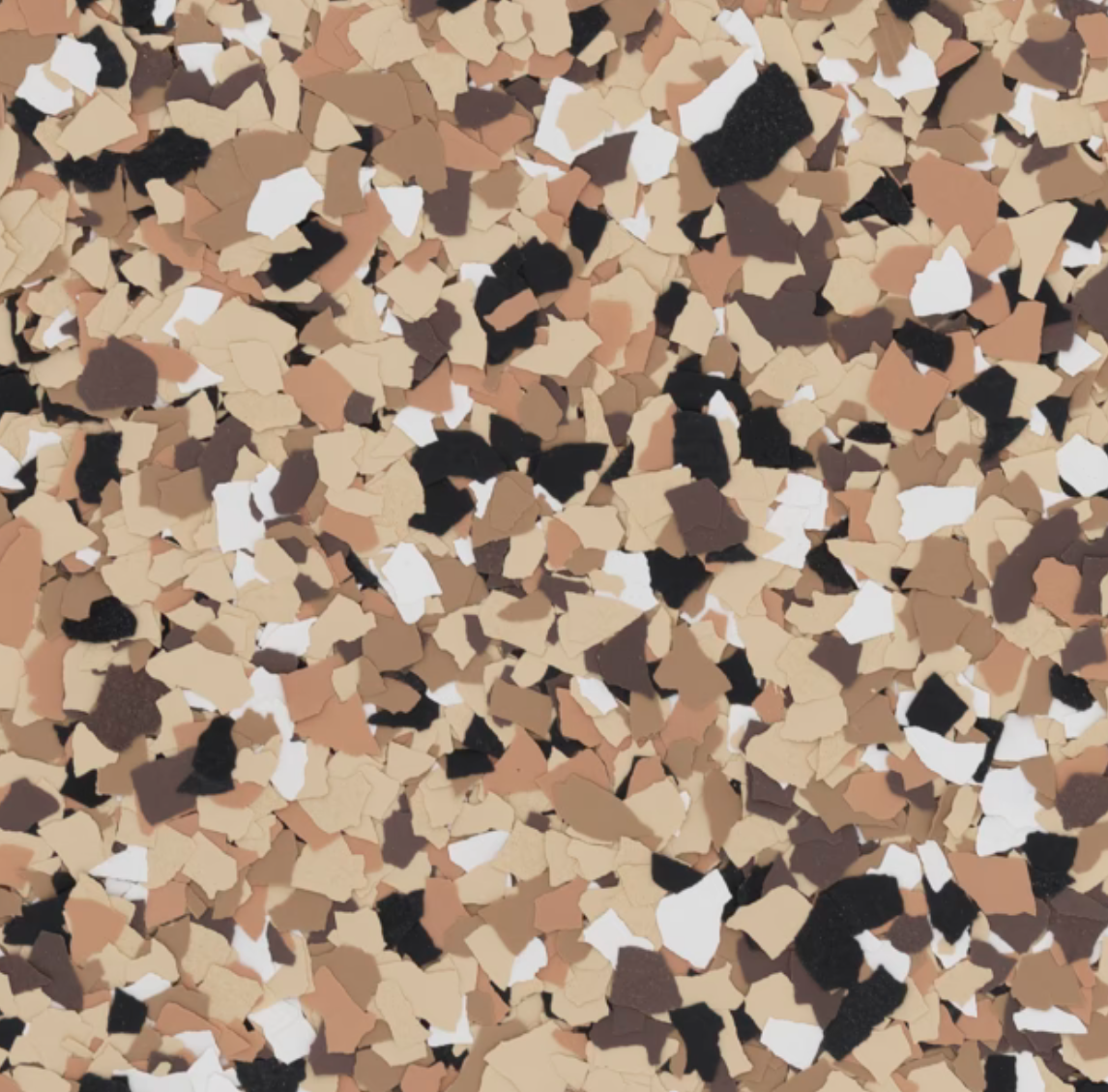 Close-up view of a speckled, multicolored surface, featuring an abstract pattern of brown, white, black, and beige irregular shapes.