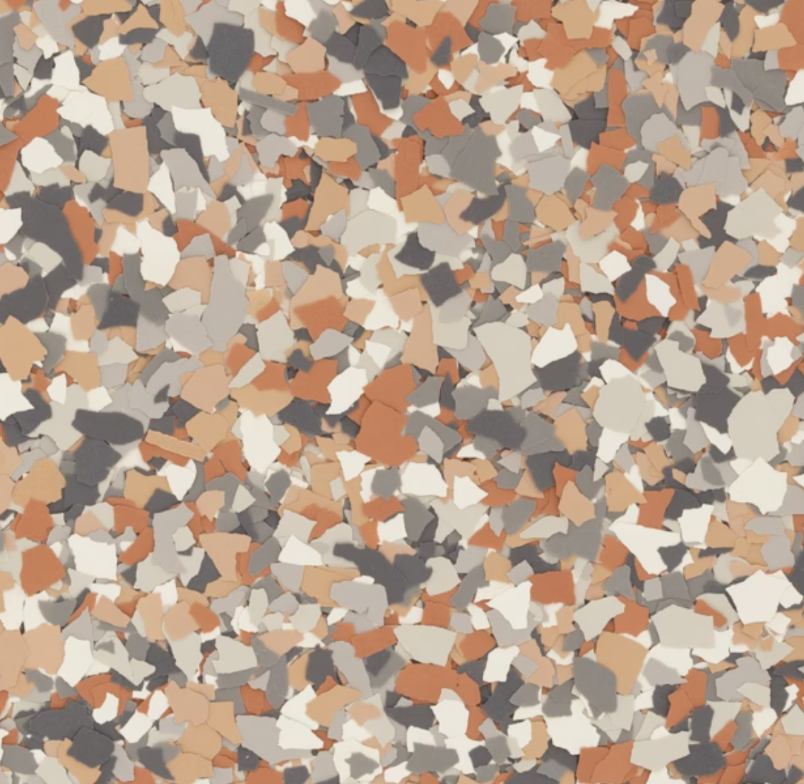 Colorful terrazzo pattern with mixed tones of orange, gray, and white creating a mosaic-like appearance. Suitable for flooring or decorative surfaces.